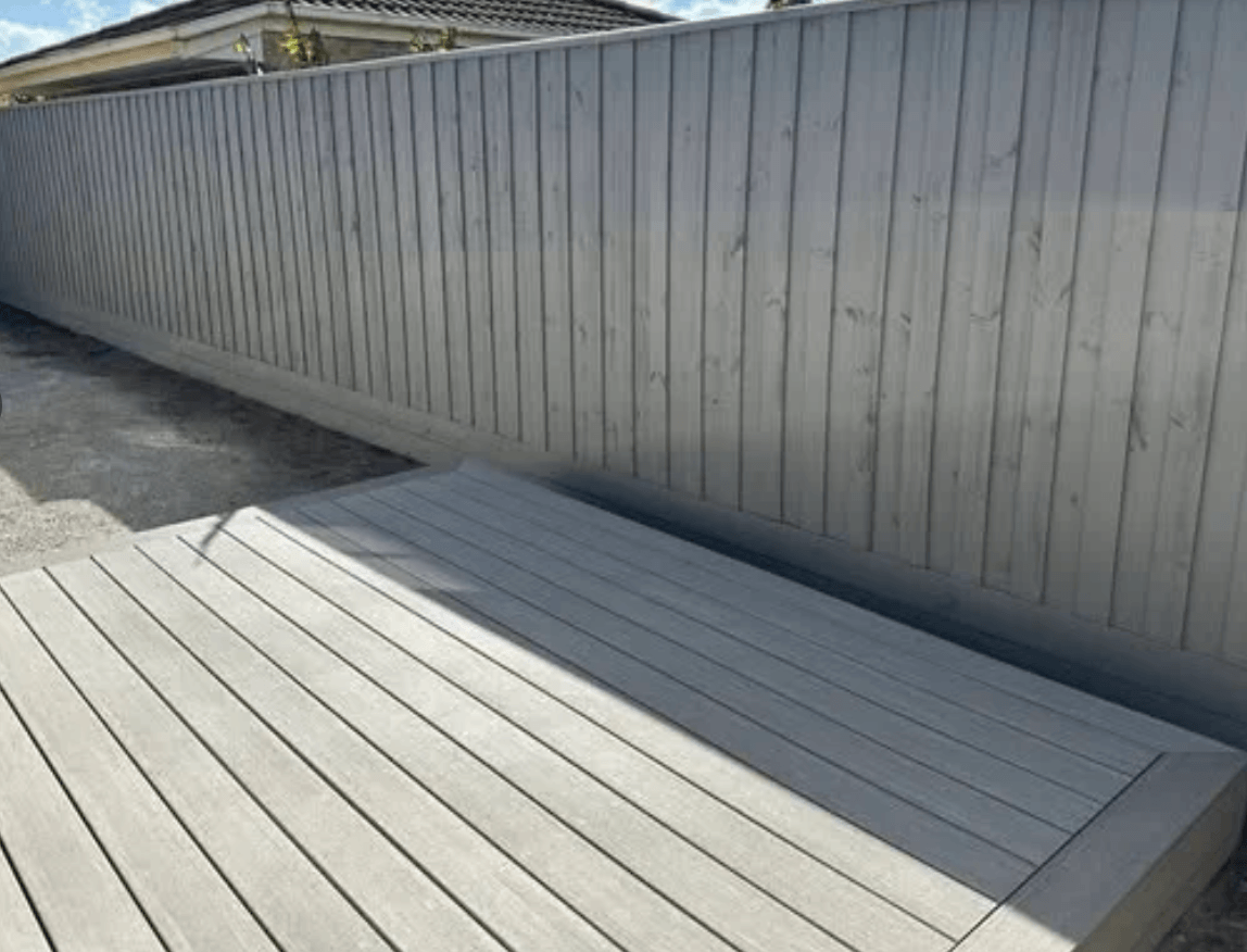 Grey painted timber paling fence and matching timber deck in Berwick, painted by Northern Star Painting