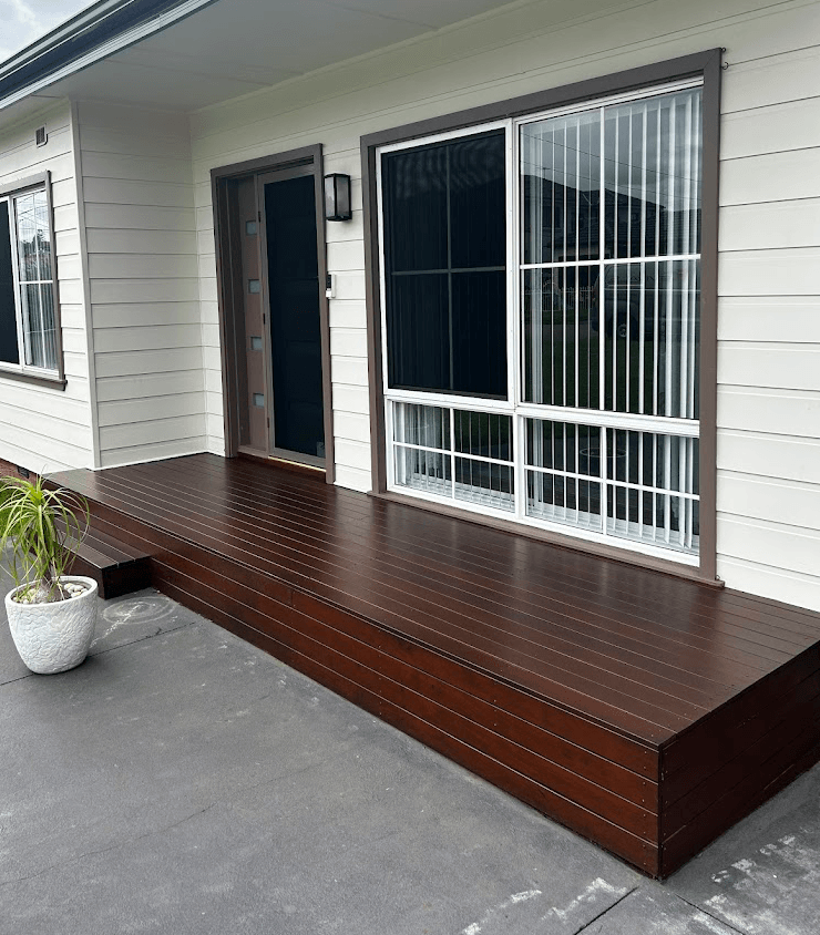 Front entry deck finished in a deep brown timber coating at a weatherboard home in Berwick, completed by Northern Star Painting