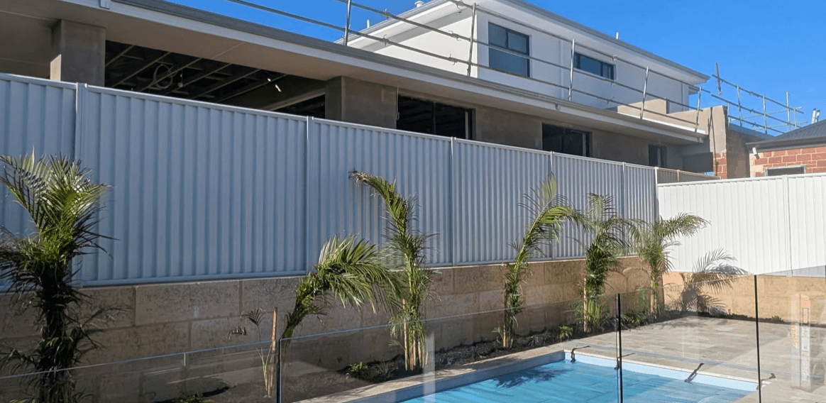 White painted Colorbond steel pool fence with timber slat feature screening in Hallam, completed by Northern Star Painting