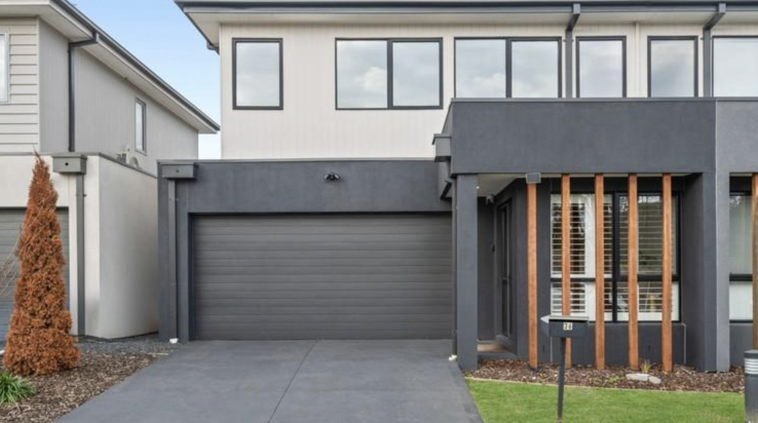 Freshly painted garage door and rendered front facade of a Berwick townhouse