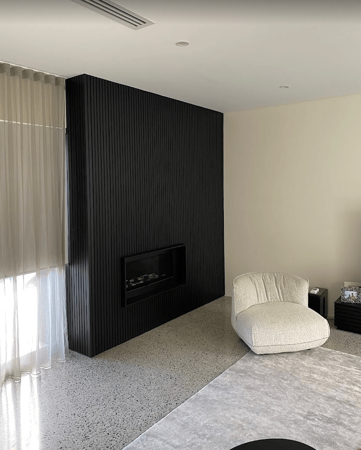 Custom dark vertical slat feature wall and interior painting completed in a modern Mornington home.