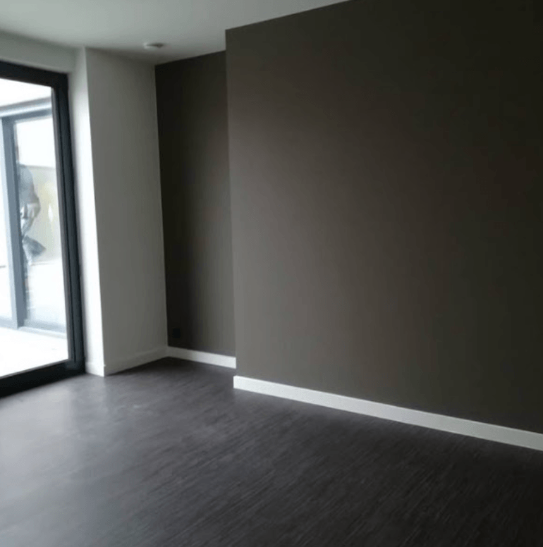 Interior living area painting with a warm taupe feature wall and white trim in Malvern by Northern Star Painting